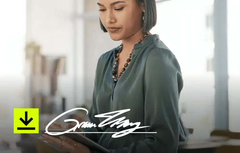 A woman in business attire working on a tablet.